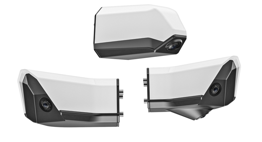 Three white and black electronic devices with smooth, angular designs are displayed on a white background. Each device has lenses and appears to be surveillance cameras or sensors shown from different angles. 