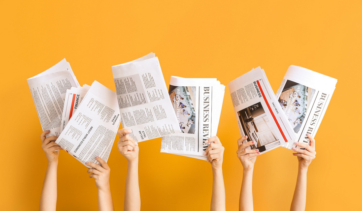 Hands with newspapers on color background.jpg