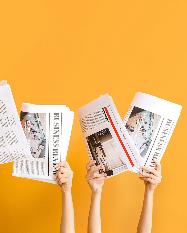 Hands with newspapers on color background.jpg