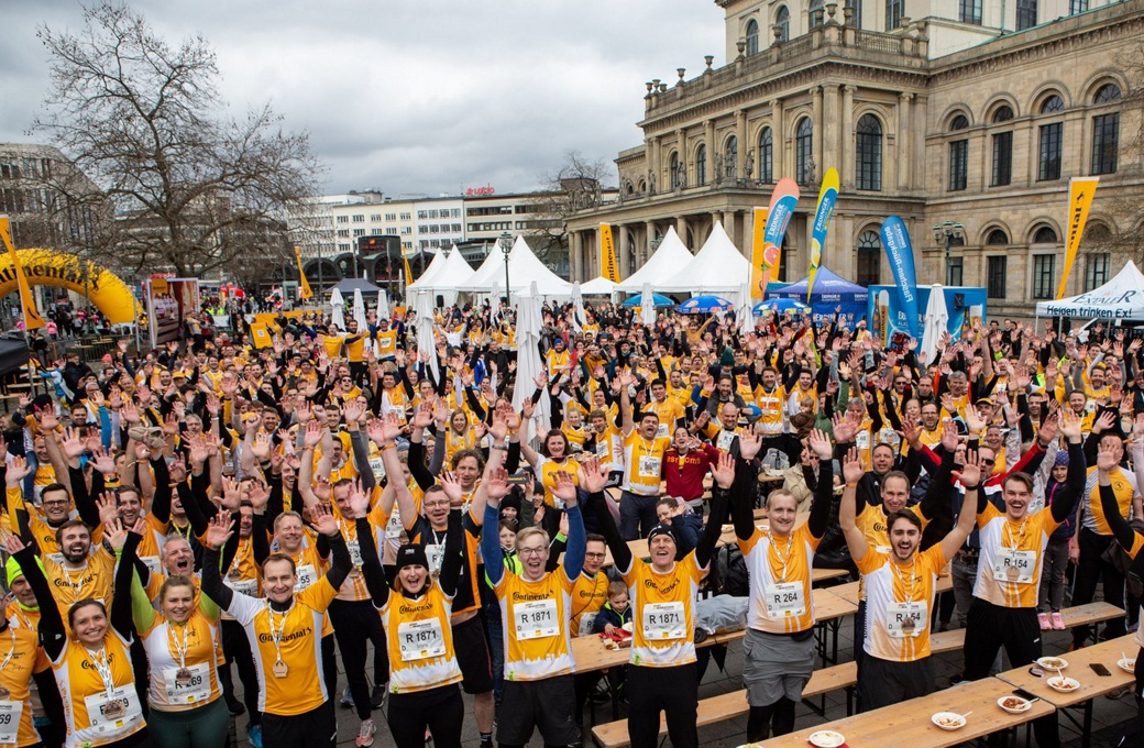 A large group of runners in yellow shirts