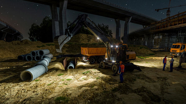 Employees work in the construction site with machines at night