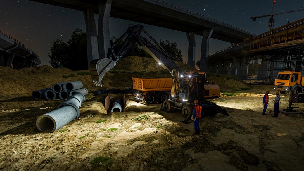 Employees work in the construction site with machines at night