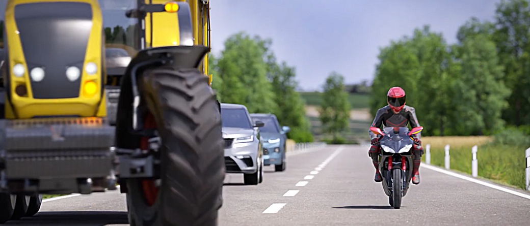 Motorcycle rides next to tractor