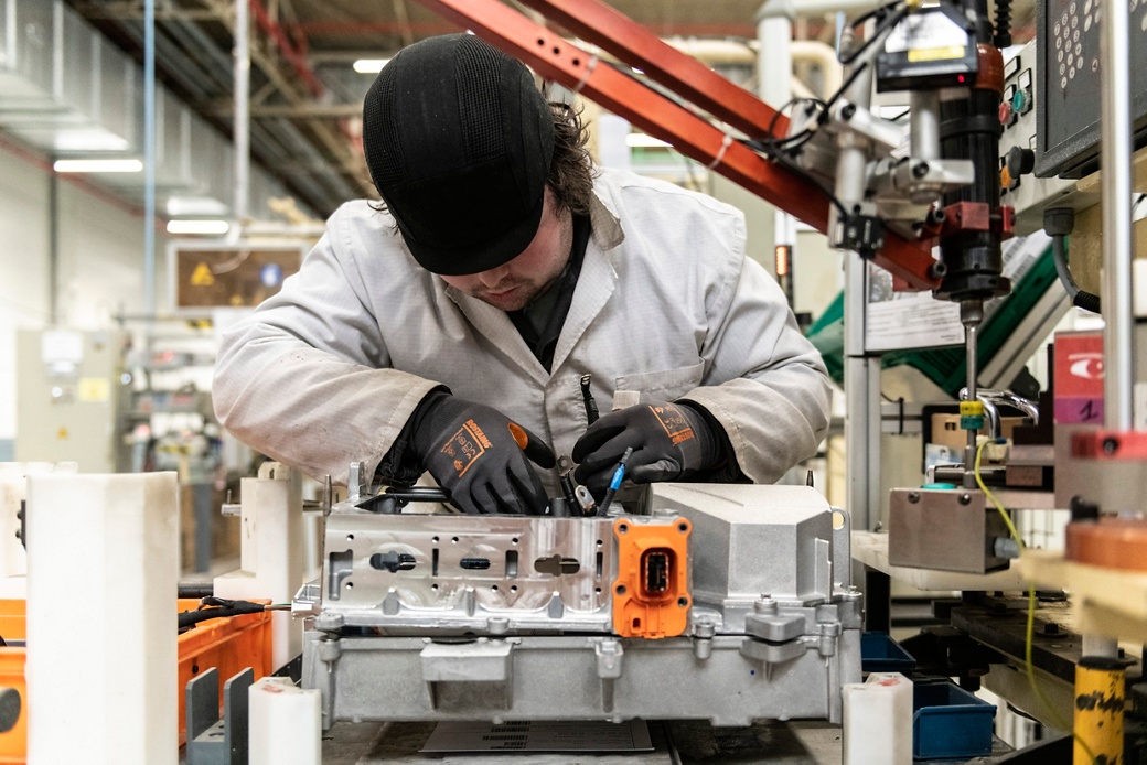 Factory worker working on electronic parts -  DCDC converter